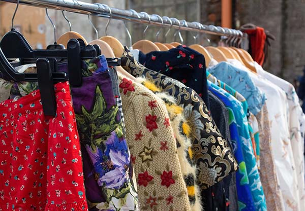 Second hand clothes on a rack in a charity shop
