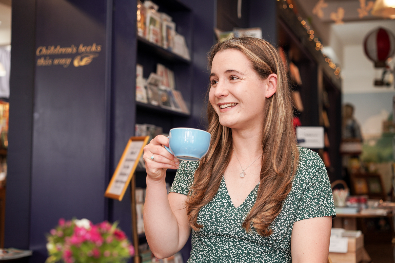 Lady drinking tea in book shop