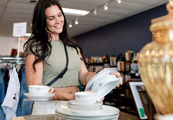 Woman buying housewares at a second hand shop